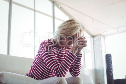 Depressed businesswoman sitting on sofa