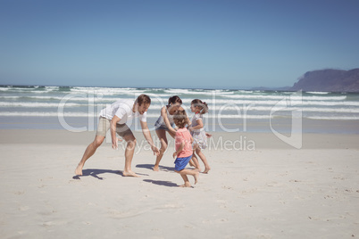 Happy family playing at beach