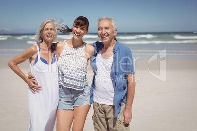 Portrait of family standing at beach