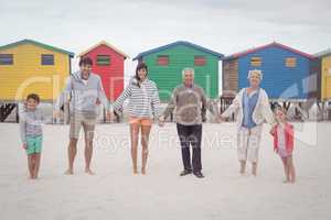 Portrait of multi-generation family holding hands at beach