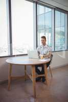 Executive using laptop at table