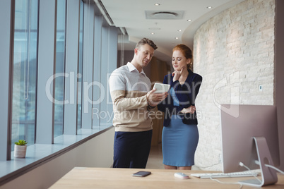 Attentive executives using digital tablet