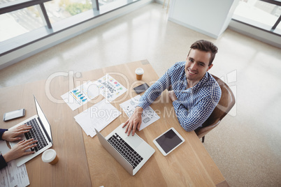 Overhead view of smiling executive working at desk