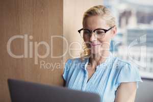 Smiling executive using laptop