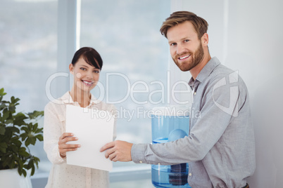 Portrait of smiling executives holding document