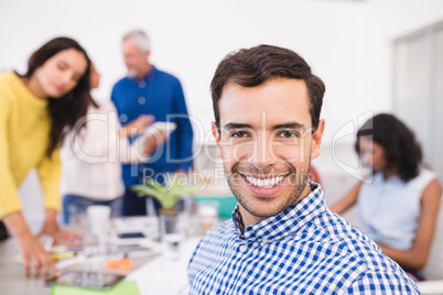 Portrait of businessman with colleagues