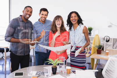 Portrait of happy business people holding document