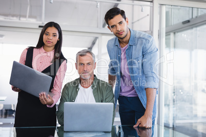 Portrait of business people with laptops