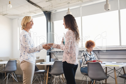 Happy 1business people shaking hands at office