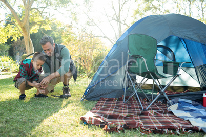 Father and son setting up a tent