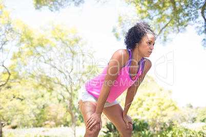 Exhausted jogger woman relaxing in the park