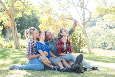 Happy family taking a selfie in the park