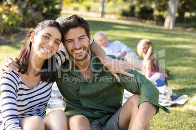 Portrait of happy couple sitting in the park