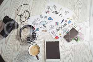 Various technologies with colorful charts and coffee on table