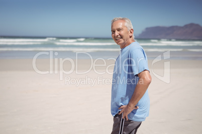 Portrait of senior man standing at beach