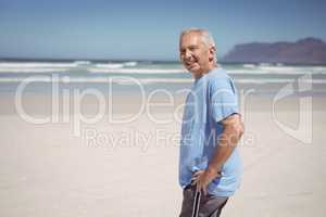 Portrait of senior man standing at beach