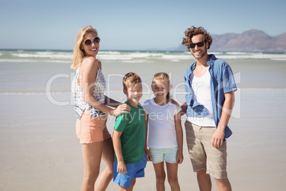 Portrait of smiling family standing at beach