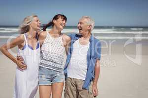 Cheerful family standing at beach