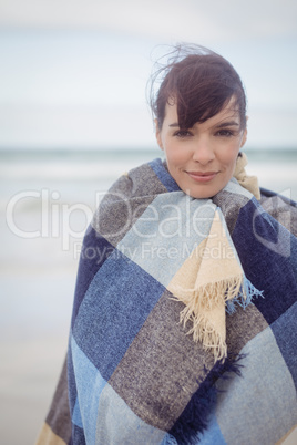 Portrait of young woman with eays closed wrapped in blanket