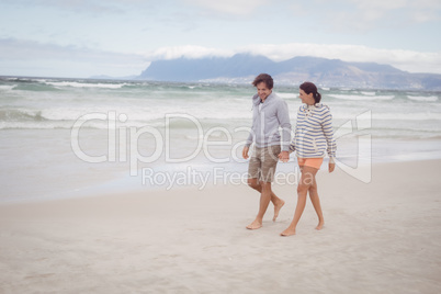 Young couple holding hands at beach