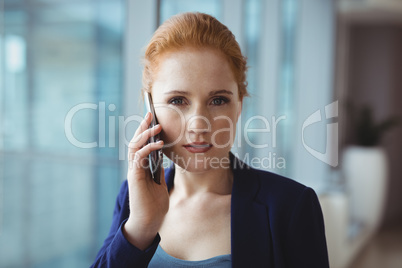 Portrait of beautiful executive talking on mobile phone