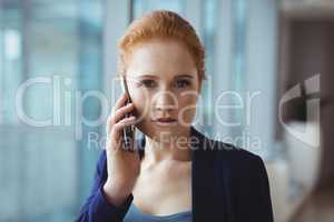 Portrait of beautiful executive talking on mobile phone