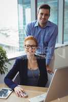 Portrait of smiling executives working at desk