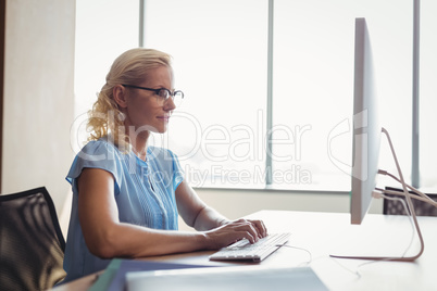 Attentive executive working at personal computer at desk
