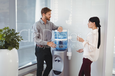 Colleagues interacting while drinking water