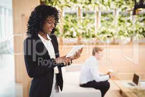 Smiling businesswoman using digital tablet