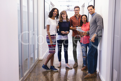 Portrait of business people standing in corridor