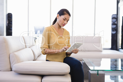 Businesswoman using tablet computer in office