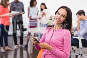 Portrait of happy businesswoman with phone