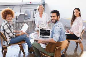 Portrait of smiling business team working together at creative office