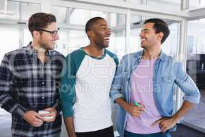 Cheerful male business colleagues standing together