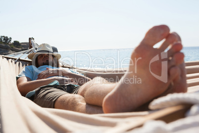 Man relaxing in hammock