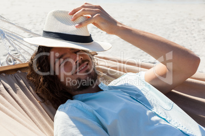 Smiling man relaxing in hammock