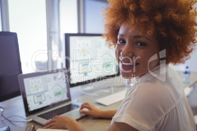 Portrait of female graphic designer working in office