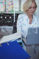 Focused businesswoman working on laptop at office