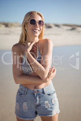 Happy young woman wearing sunglasss at beach