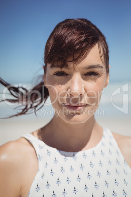 Portrait of young woman with tousled hair at beach