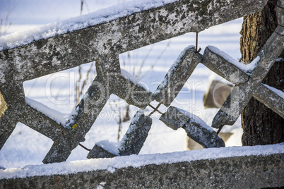 damaged concrete fence in winter