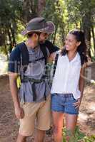 Hiker couple looking at each other in forest