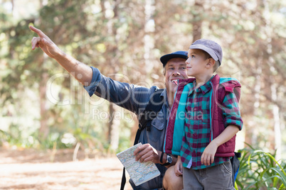 Boy looking away while father pointing