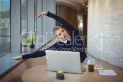 Executive stretching her hands while working