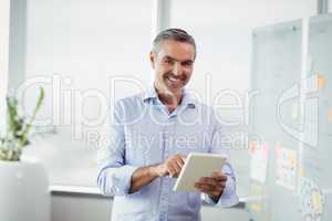 Portrait of smiling executive using digital tablet