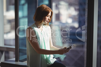 Female executive using mobile phone
