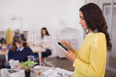 Side view of businesswoman using digital tablet