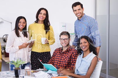 Portrait of happy business people at desk