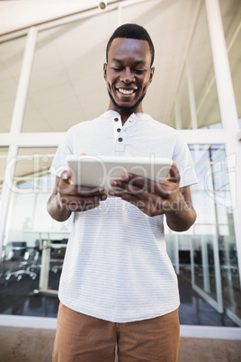 Smiling businessman using tablet computer